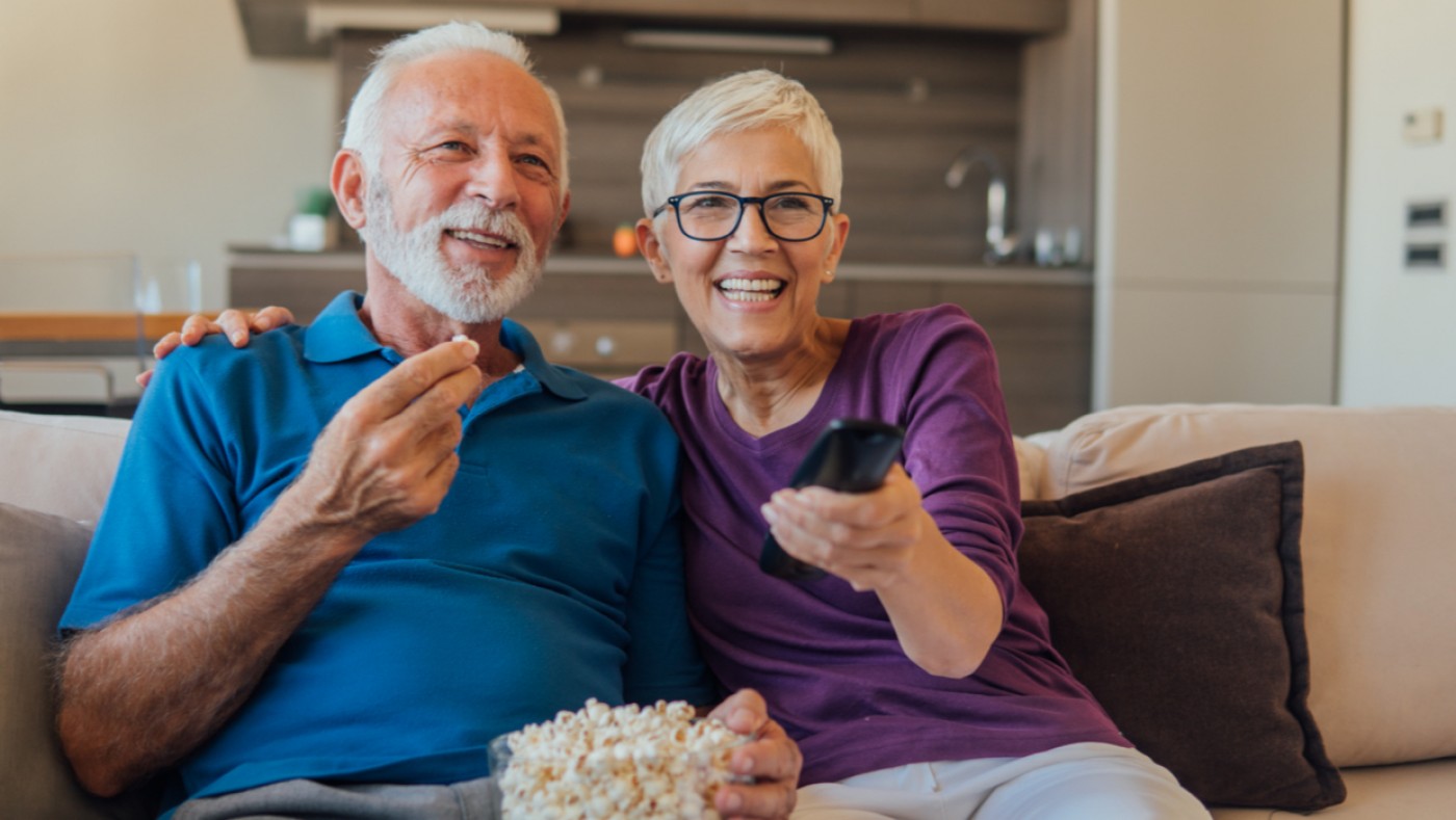 Adult couple watching tv at home