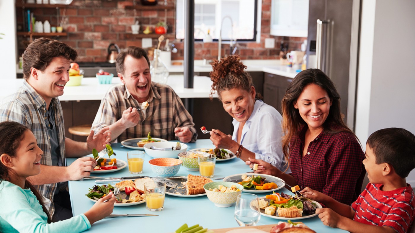 Family eating dinner and smiling