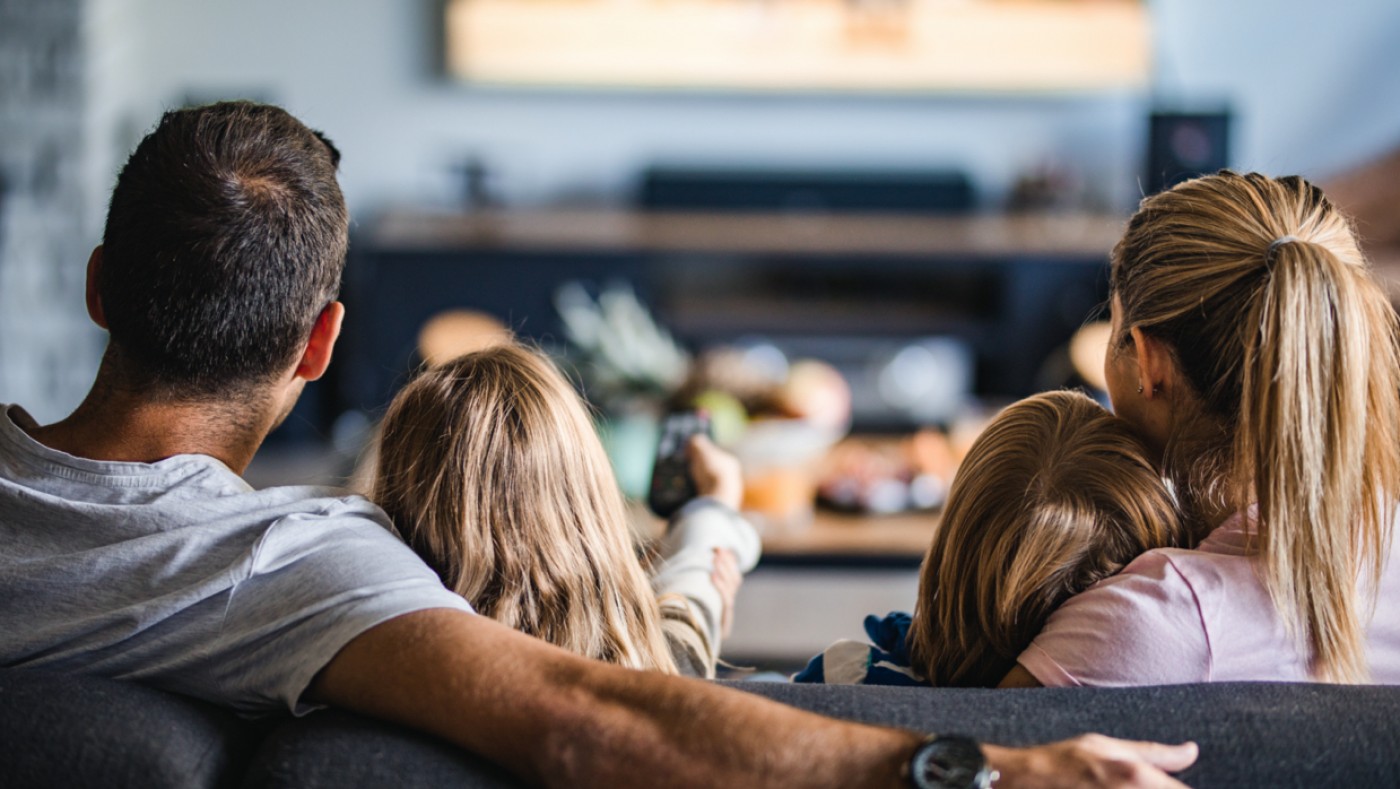 Family with kids watching tv