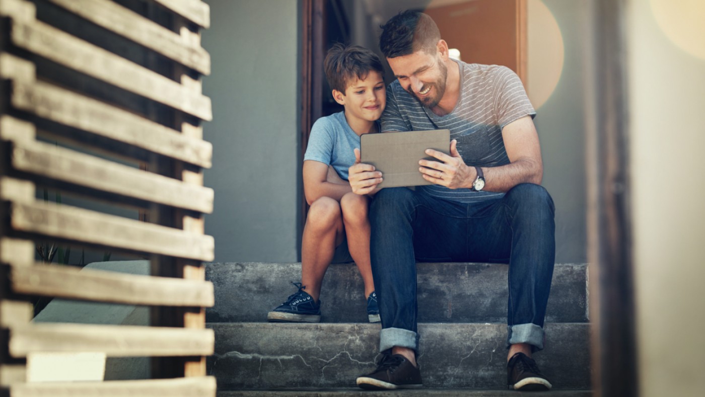 Father and son watching video on ipad