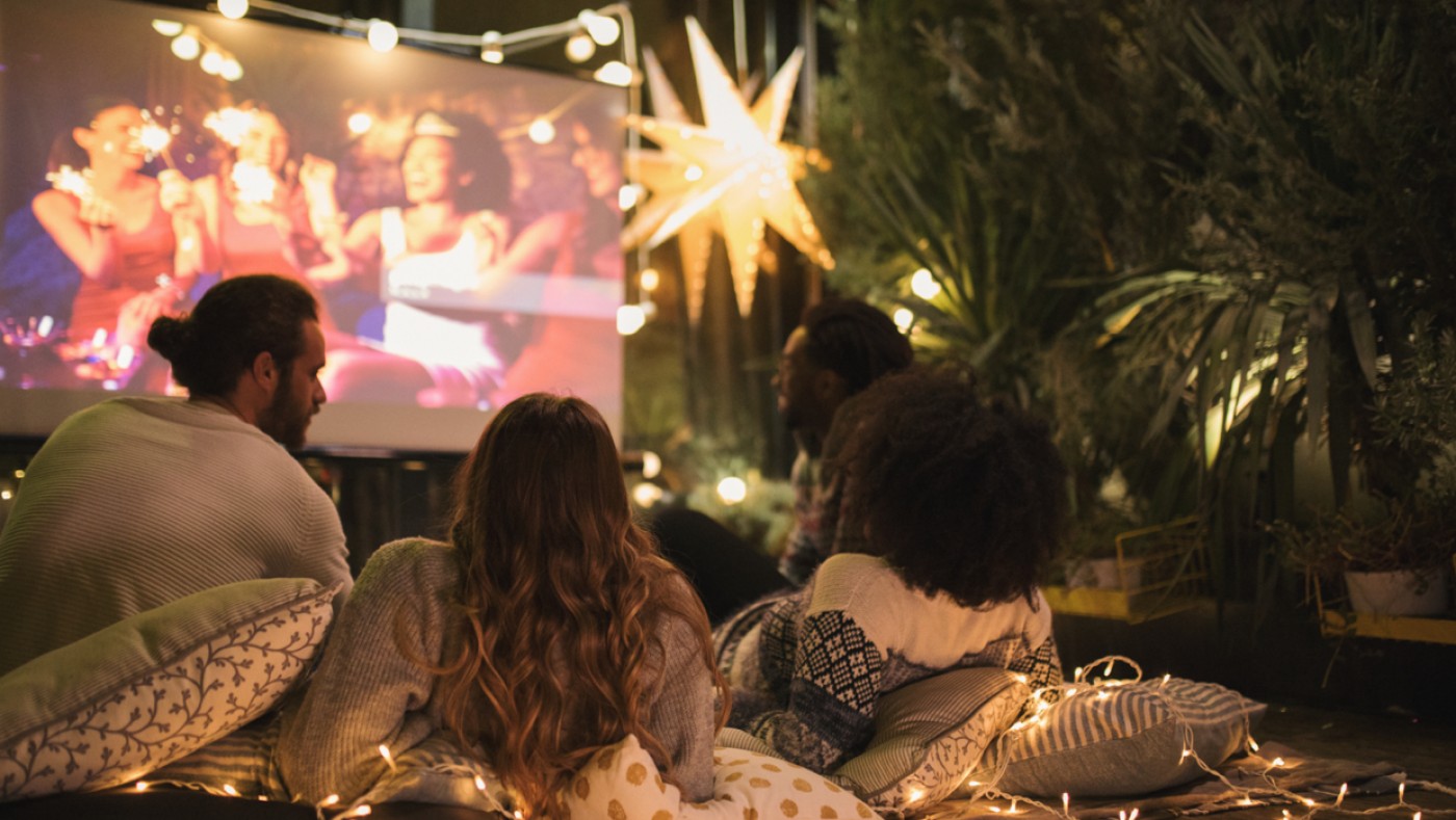 Friends watching movie on projector