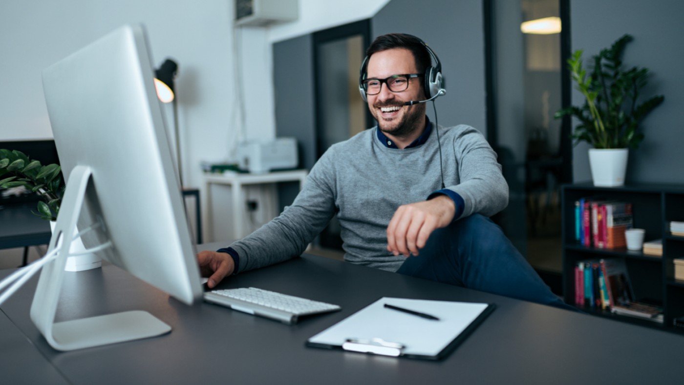 Man using office computer and smiling