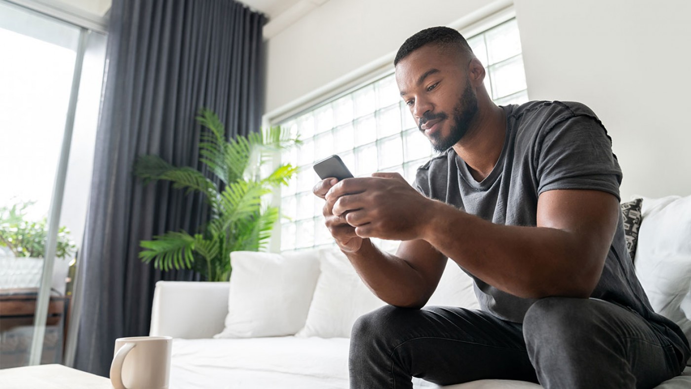 Man using cell phone on couch