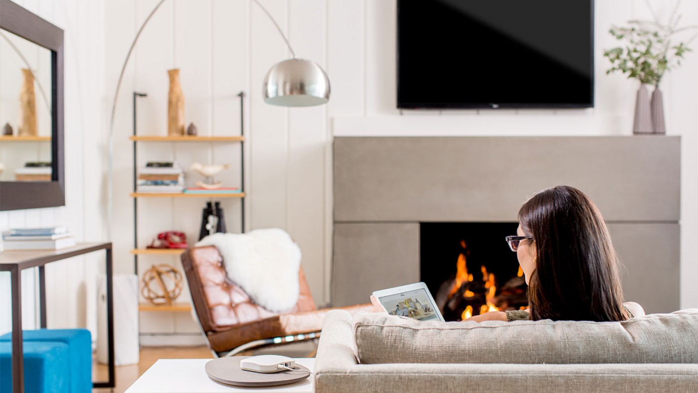 Woman on couch using alexa ask