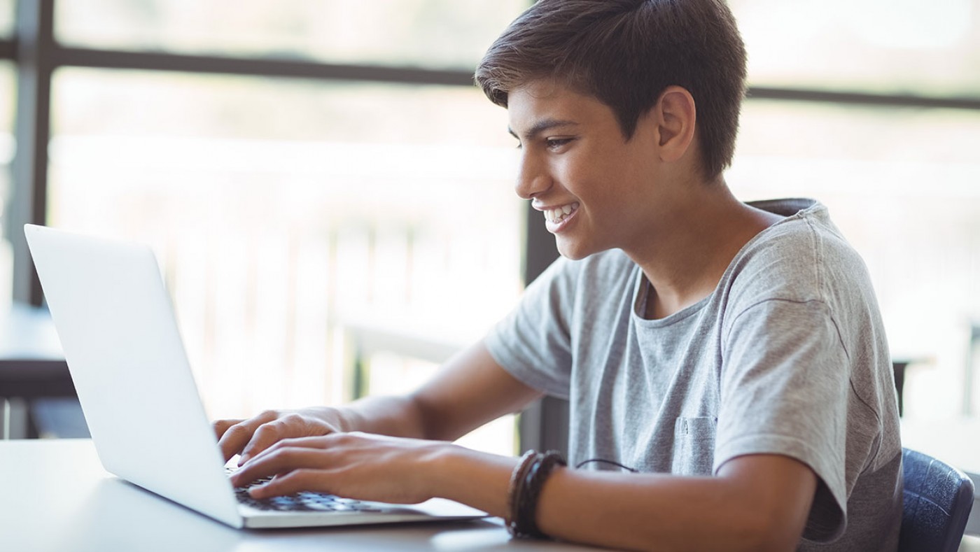 young boy using laptop