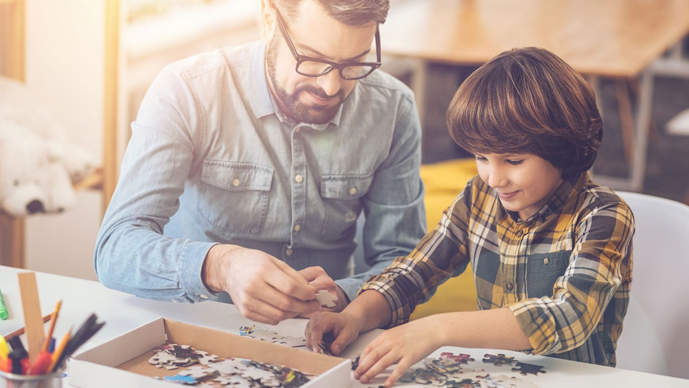 father and son doing a puzzle