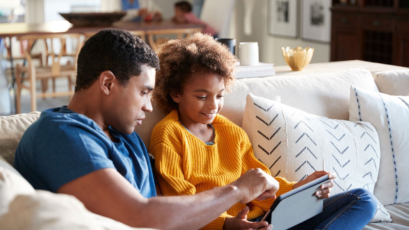 father and son looking at an ipad