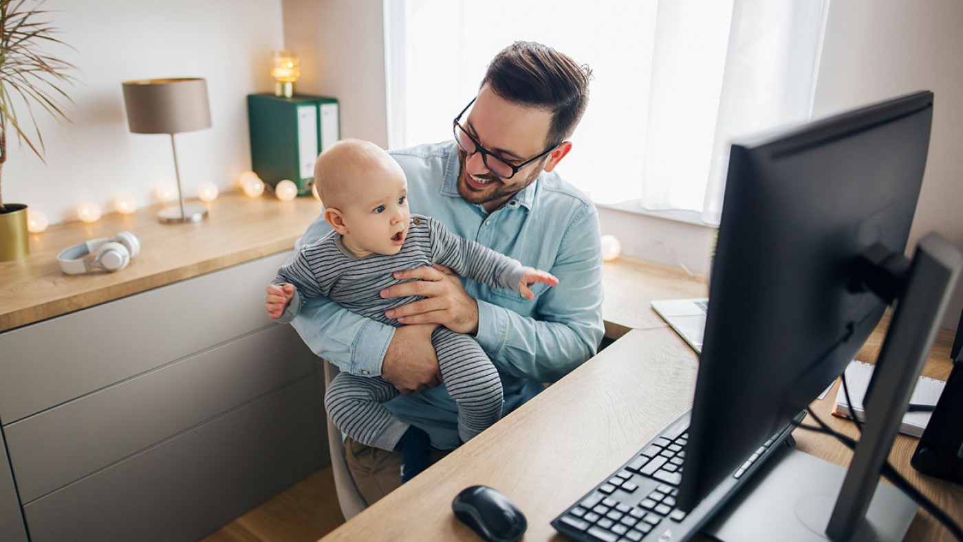 father and baby using a desktop computer