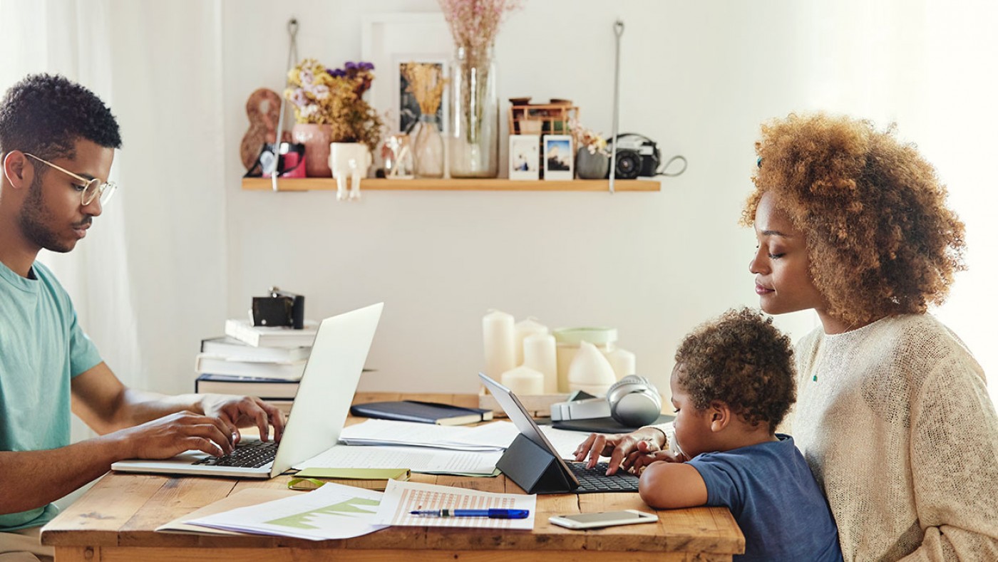 family using a laptop and an ipad at the table