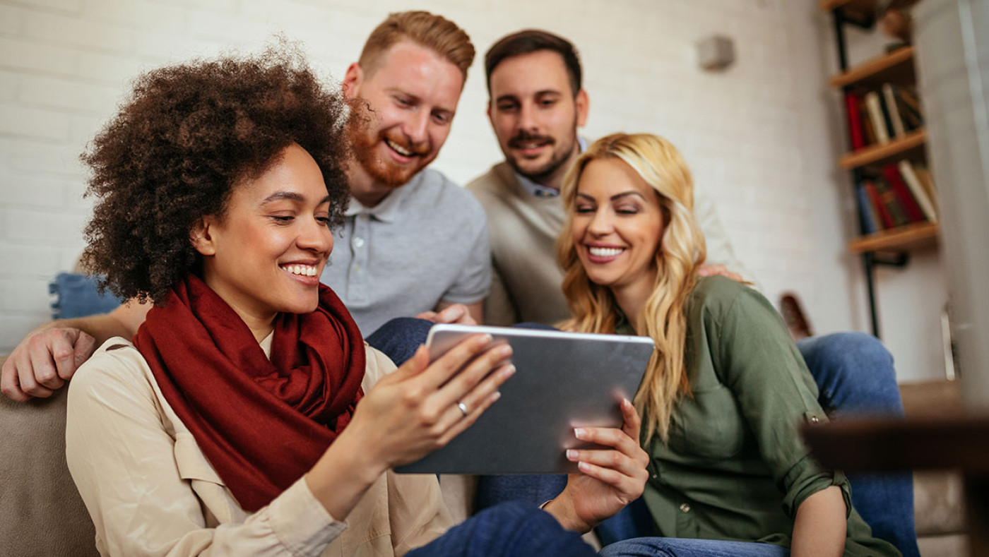 group of friends watching an ipad