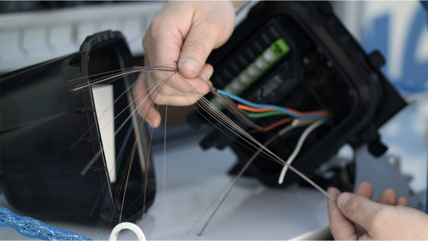 close up of tech holding fiber cables