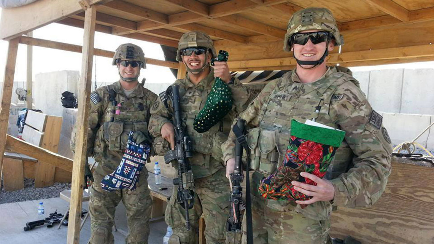 Male soldiers holding stockings