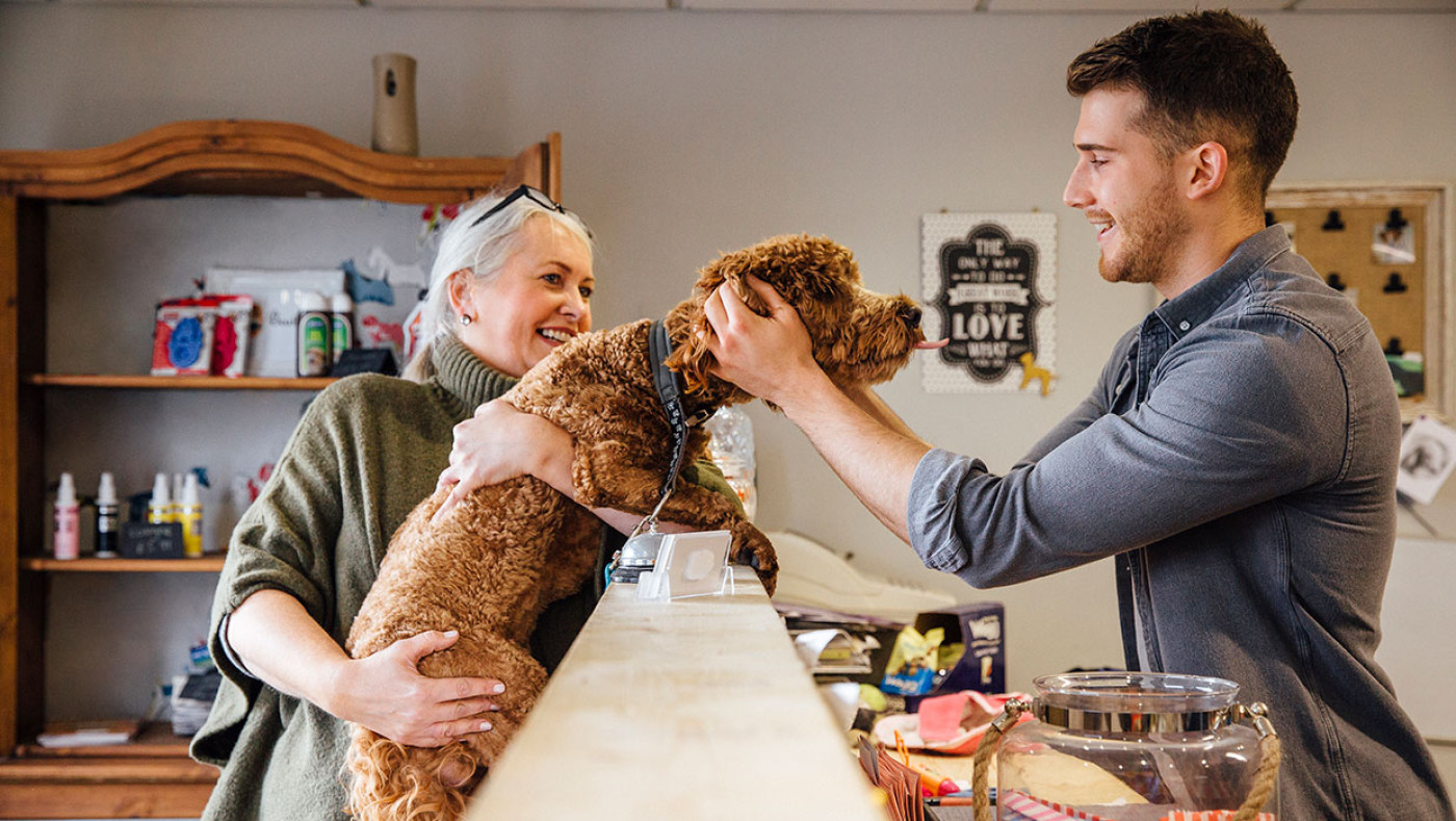 small business worker with customer and a dog