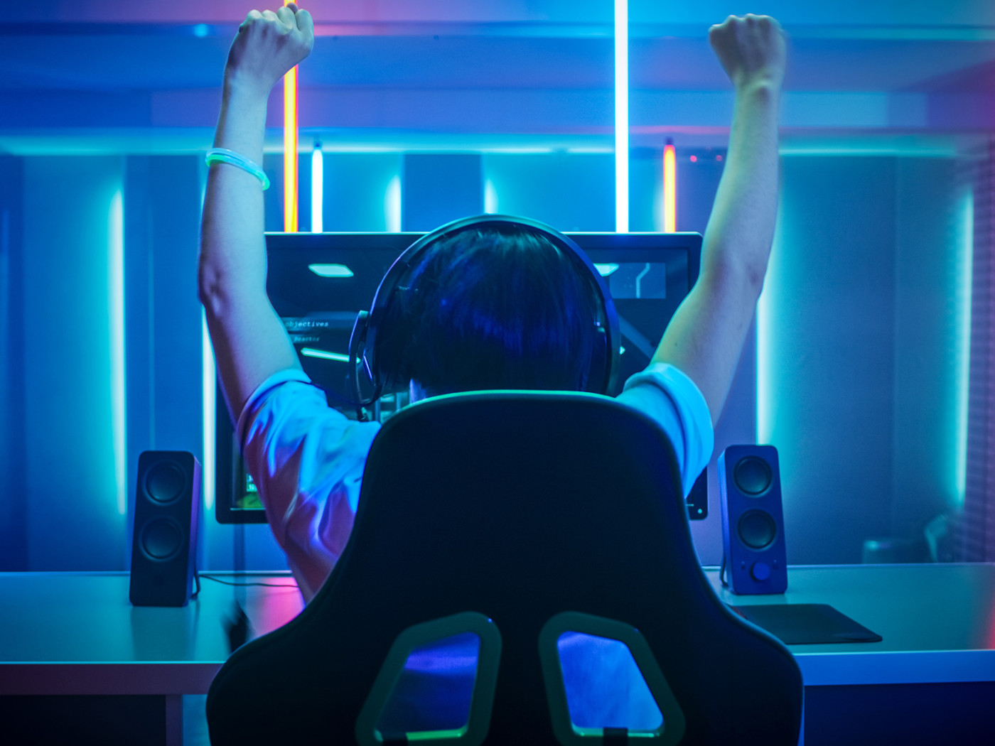 Teen gaming with hands in the air